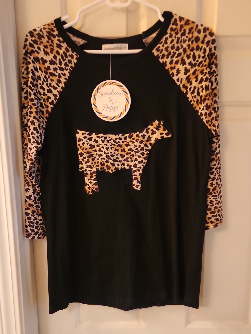 Sunshine & Rodeos Women's Black Long Sleeve Tee with Leopard Cow Applique